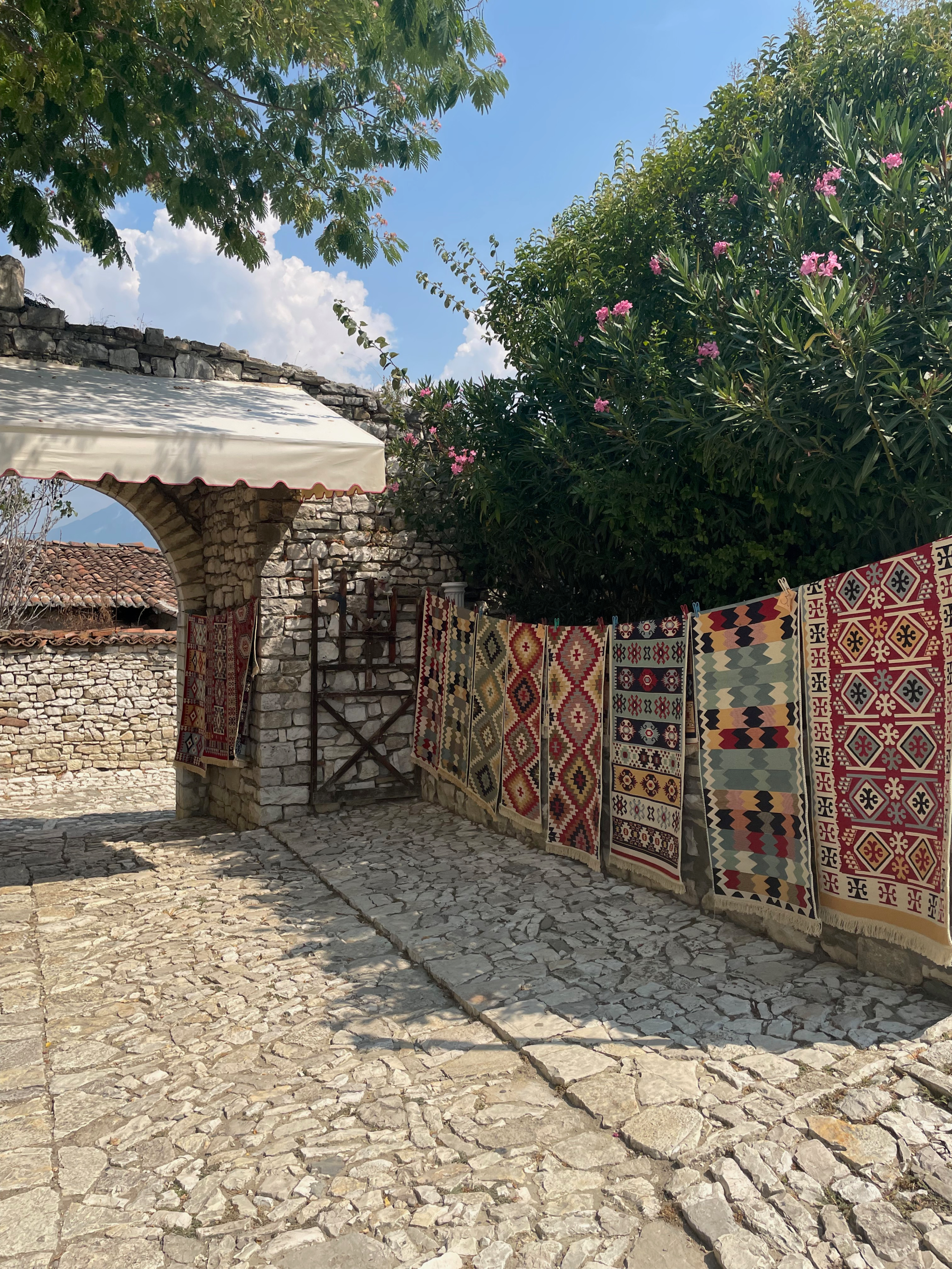 Traditional Albanian rugs hanging on display in Albanian fortress